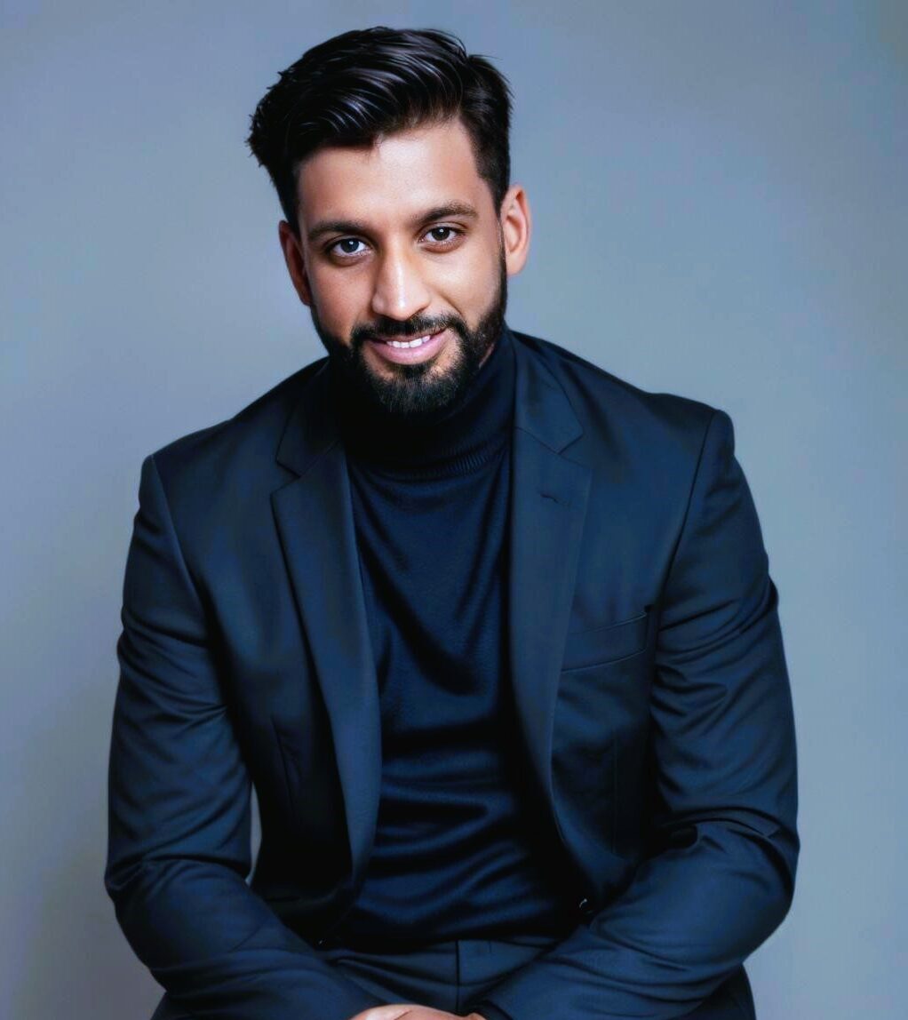 Harman Gill in a suit, professional portrait.