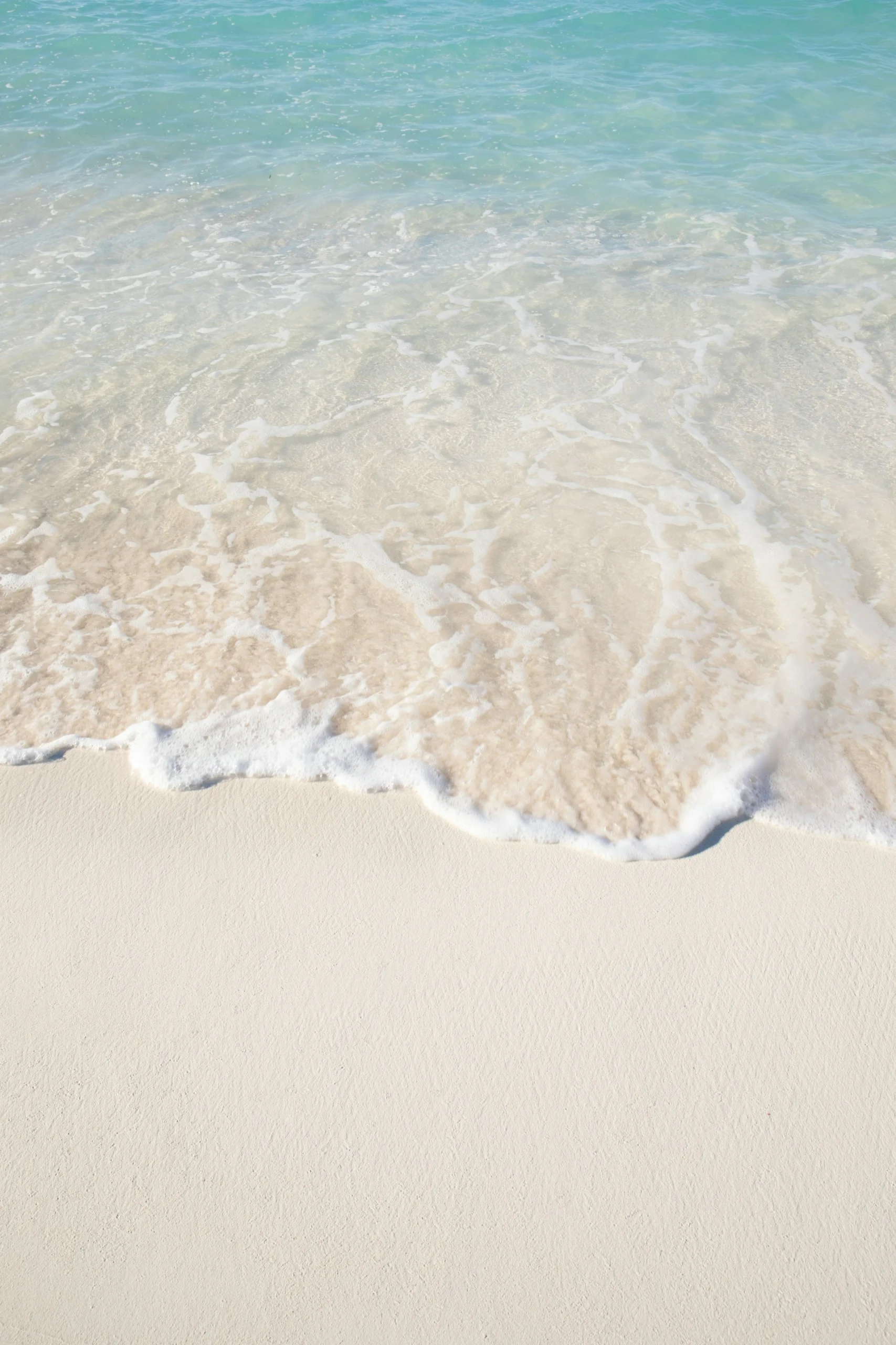A peaceful beach scene with gentle waves.